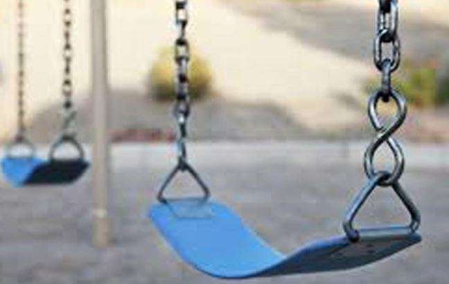 A swing strikes the schoolgirl's head at a public park; the family receives Dh700,000